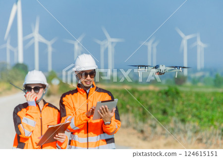 Engineer team using drone technology device to survey service maintenance wind turbine power station 124615151
