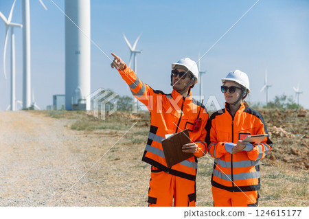 Engineer workers teamwork working together service maintenance wind turbine clean power green energy 124615177