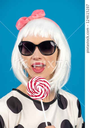 Retro style woman with white wig sunglasses and lollipop Retro style woman with white wig sunglasses and lollipop 124615287