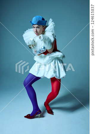 Fashion-forward woman pressing hands against corset, playing with form and silhouette in artistic styling. 124615837