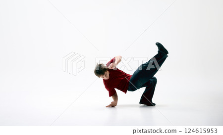 Breakdancer, dressed streetwear, spinning low on one hand against white background, motion flowing seamlessly. 124615953