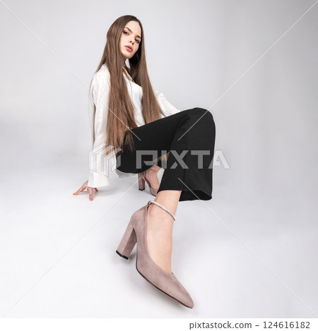 Beautiful woman with white blouse and black trousers studio portrait 124616182
