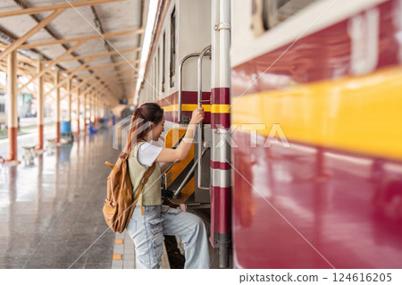 Climbing Aboard and Exploration. A traveler uses the steps to board the train. 124616205