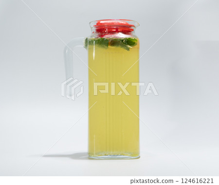 Refreshing Homemade Lemonade in Glass Jar with Mint Leaves on White Background 124616221