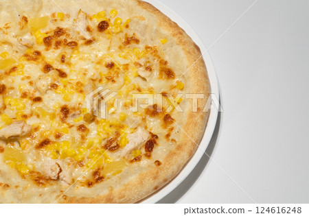 Freshly Baked Pizza with Melted Cheese, Chicken Chunks, Sweet Corn, and Crispy Crust on White Plate 124616248