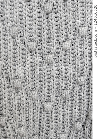 knitted texture, grey sweater or carpet. industrial knitting of clothes made of wool, acrylic or cotton. 124616520