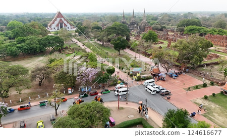 Tourists ride an elephant through the streets of Ayutthaya cultural. Tourists ride an elephant through the streets of Ayutthaya cultural. 124616677