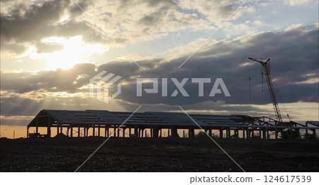 Silhouette. construction. large construction site including construction crane and building. Construction site sunset Silhouette. construction. large construction site including construction crane and building. Construction site sunset 124617539
