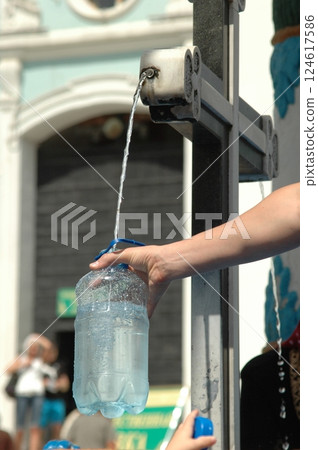 Filling Bottle at Outdoor Water Fountain on a Sunny Day Filling Bottle at Outdoor Water Fountain on a Sunny Day 124617586