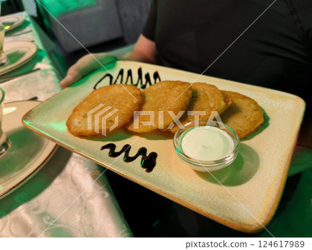 Vegetarian vegetable cutlet from carrot, zucchini, potato with sauce. Healthy diet food. Close up view 124617989