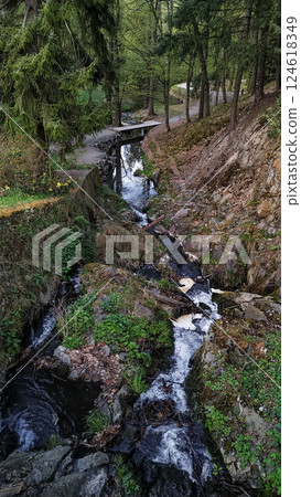 Small wooden bridge crossing a stream in pruhonice, czechia 124618349