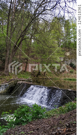 Waterfall cascading in pruhonice park, czech republic, creating a tranquil oasis 124618361