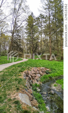 Winding path along a stream in pruhonice park, czechia 124618362