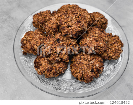 Delicious homemade oatmeal cookies resting on elegant glass plate copy space Delicious homemade oatmeal cookies resting on elegant glass plate copy space 124618432