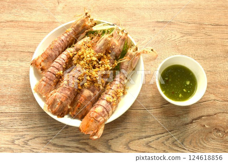 fried mantis shrimp with chop crispy garlic on plate dipping Thai spicy seafood sauce fried mantis shrimp with chop crispy garlic on plate dipping Thai spicy seafood sauce 124618856