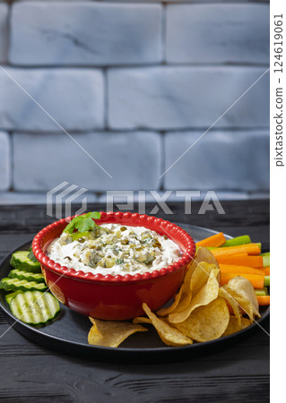 creamy yogurt pickles caper dill dip in red bowl 124619061
