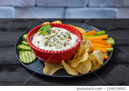 creamy yogurt pickles caper dill dip in red bowl 124619062
