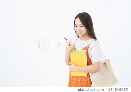 Female college student using a smartphone 124619085