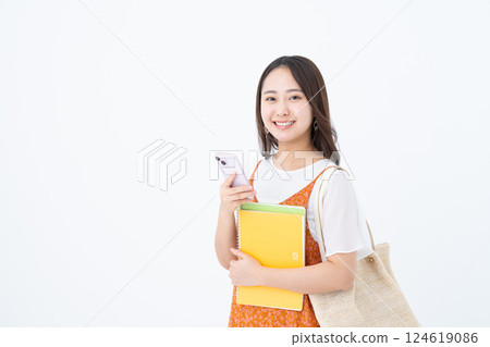 Female college student using a smartphone Female college student using a smartphone 124619086