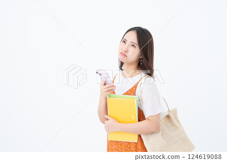 Female college student using a smartphone 124619088