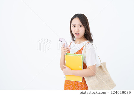 Female college student using a smartphone Female college student using a smartphone 124619089