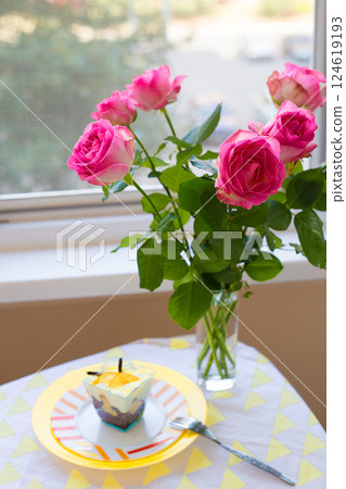 bouquet of pink roses on the table with dessert 124619193