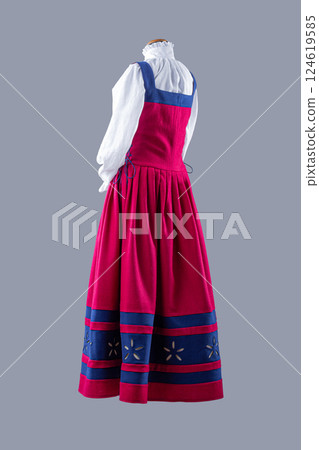 Elegant Red and Blue Medieval Dress with White Blouse. Beautiful historical garment featuring a vibrant red dress with blue accents and a delicate white blouse. 124619585