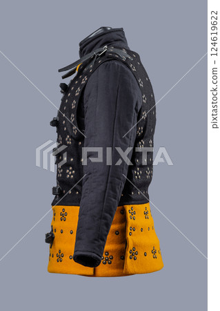 Two-Tone Medieval Brigandine Armor with Buckles. Unique torso protection featuring contrasting yellow and black panels with decorative rivets and leather strap closures. 124619622