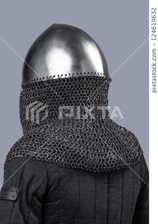 Simple Norman Helmet with Nasal Bar and Chainmail. Classic medieval head protection featuring a central nose guard and attached chainmail neck cover. 124619632