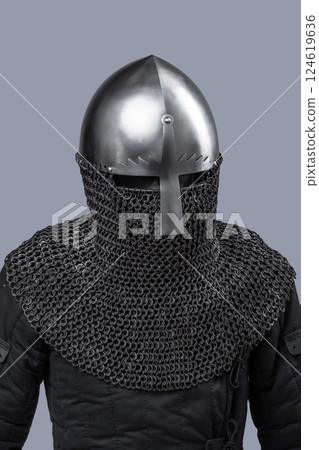 Simple Norman Helmet with Nasal Bar and Chainmail. Classic medieval head protection featuring a central nose guard and attached chainmail neck cover. 124619636
