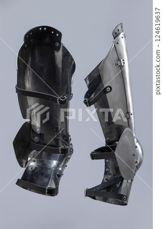 Steel Plate Leg Armor for Medieval Knight. Full leg protection with articulated segments from knee to ankle. Steel Plate Leg Armor for Medieval Knight. Full leg protection with articulated segments from knee to ankle. 124619637