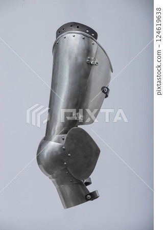 Steel Plate Leg Armor for Medieval Knight. Full leg protection with articulated segments from knee to ankle. 124619638