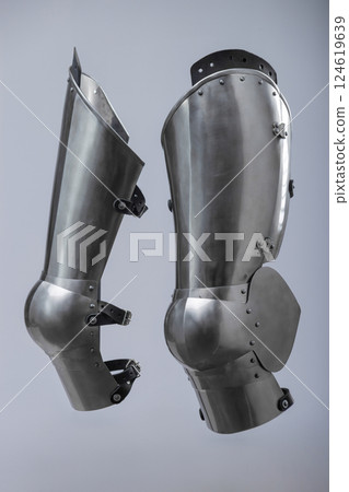Steel Plate Leg Armor for Medieval Knight. Full leg protection with articulated segments from knee to ankle. 124619639