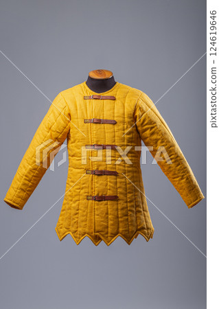 Yellow Padded Gambeson Jacket. Medieval quilted under-armor with leather strap closures. Yellow Padded Gambeson Jacket. Medieval quilted under-armor with leather strap closures. 124619646