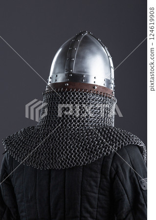 Simple Medieval Knight's Nasal Helmet with Chainmail. Classic head protection featuring a central nose guard and attached chainmail collar. 124619908