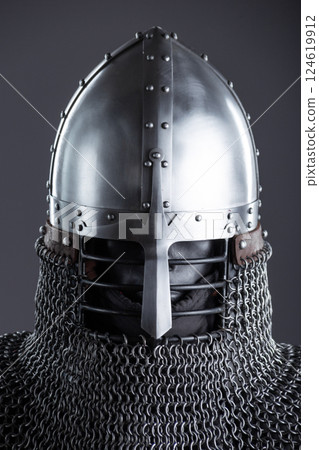 Simple Medieval Knight's Nasal Helmet with Chainmail. Classic head protection featuring a central nose guard and attached chainmail collar. 124619912