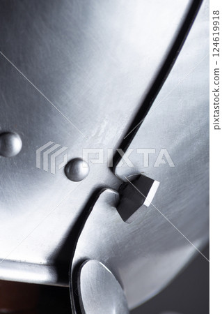 Close-up of Articulated Metal Helmet Visor. Detailed view of the visor mechanism with overlapping plates and rivets. 124619918