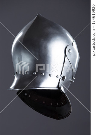 Polished Silver Medieval Armet Helmet with Perforated Visor. This shiny silver armet features a rounded skull, a protective bevor, and a visor with multiple small perforations. 124619920