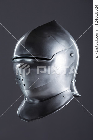 Polished Silver Medieval Armet Helmet with Perforated Visor. This shiny silver armet features a rounded skull, a protective bevor, and a visor with multiple small perforations. 124619924