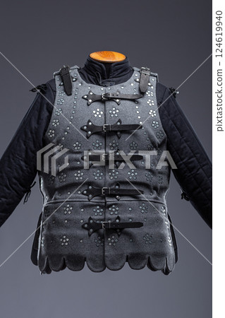 Gray Medieval Brigandine Armor with Leather Straps. This gray brigandine features overlapping metal plates riveted to a fabric base, secured with leather straps. 124619940