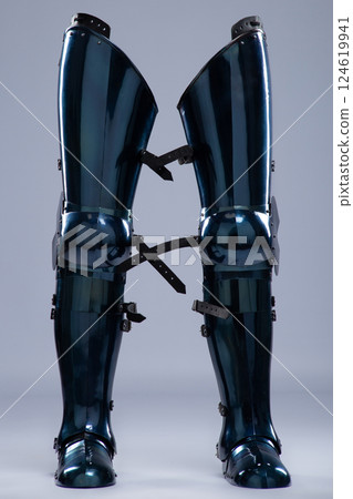 Shiny Steel Medieval Leg Armor. Full leg protection with straps and buckles detail. 124619941
