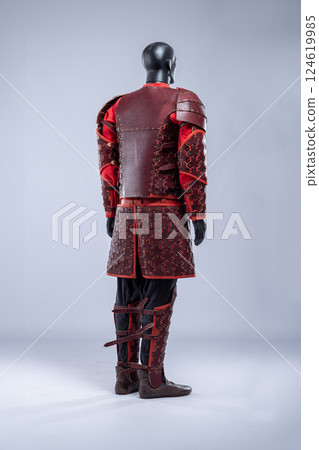 Brown Leather Fantasy Armor Set for LARP Cosplay. Full costume on a mannequin with intricate details and red accents. Brown Leather Fantasy Armor Set for LARP Cosplay. Full costume on a mannequin with intricate details and red accents. 124619985
