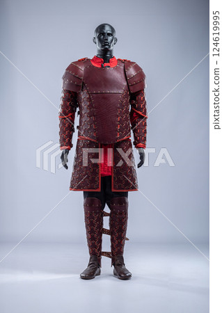 Brown Leather Fantasy Armor Set for LARP Cosplay. Full costume on a mannequin with intricate details and red accents. Brown Leather Fantasy Armor Set for LARP Cosplay. Full costume on a mannequin with intricate details and red accents. 124619995
