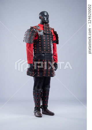 Full Black and Red Leather Armor Set on Mannequin. Warrior costume with cuirass, padded jacket, pants, and leg protection. 124620002