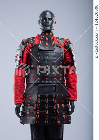 Black and Red Leather Armor Set on Mannequin. Full medieval warrior outfit with detailed stitching and metal accents. 124620006