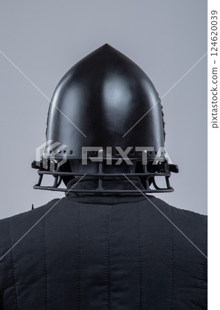 Black Steel Helmet with Face Mask. Grotesque medieval head protection with decorative wings. 124620039