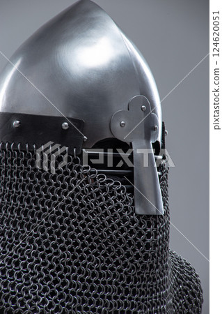 Silver Norman Helmet with Nasal Bar. This image shows a shiny silver Norman helmet, characterized by its conical shape and a prominent nasal bar extending down the front for facial protection. It also 124620051