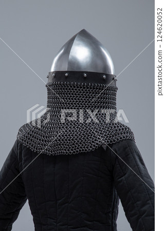 Silver Norman Helmet with Nasal Bar. This image shows a shiny silver Norman helmet, characterized by its conical shape and a prominent nasal bar extending down the front for facial protection. It also 124620052
