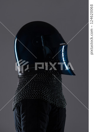Elegant Dark Blue Bascinet Helmet with Chainmail. Sophisticated medieval head protection featuring a sleek design, elongated visor, and attached chainmail. 124620068