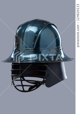 Dark Metal Helmet with Wide Brim and Grill Visor. This image shows a dark, possibly gunmetal grey, helmet with a wide, slightly sloping brim and a black grill-like visor covering the face. 124620115